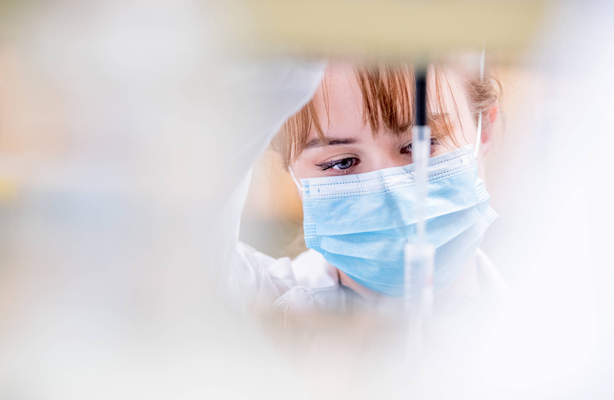 student pipetting in tube.